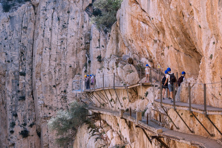 El Chorro, Spain, April 2023: People walking the Caminito Del Rey in the Desfiladero de los Gaitanes, a gorge carved by the Guadalhorce river in the province of MÃ¡laga, Spainのeditorial素材