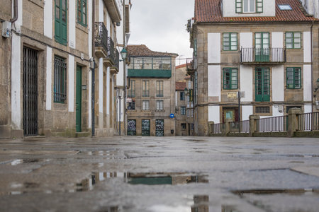 Santiago de Composteal, Spain, September 11th 2023: Low angle view on the wet streets of Santiago de Compostela during a rainy dayのeditorial素材