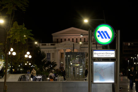 Piraeus, Greece, November 26th 2023: Night view of Dimotiko Theatro subway station entrance in Piraeus, Greeceのeditorial素材