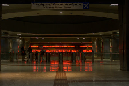Athens, Greece, November 27th 2023: Night shot of entrance of the metro station with direction Dimotiko Theatro and Airportのeditorial素材