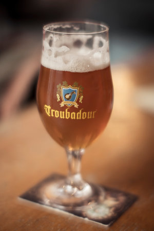 Mechelen, Belgium, January 27th 2024: illustrative editorial: Glass of Troubadour Magma Belgian beer from brewery Musketeers in Belgium. Selective focus.のeditorial素材