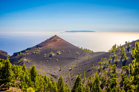 Nature and landscape on the ruta de los volcanes hike on La Palma, Canary Islands of Spain. El Hierro island in de background, high above the cloudsの写真素材