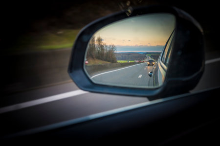 Tellin, Belgium, December 24th 2025: Side mirror view on the landscape and highway of E411, Autoroute des Ardennes in Belgiumのeditorial素材