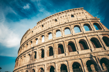 The ancient Colosseum in Rome at sunsetの写真素材