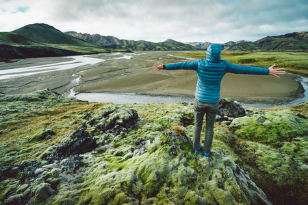 young woman looking at majestic icelandic landscapeの写真素材
