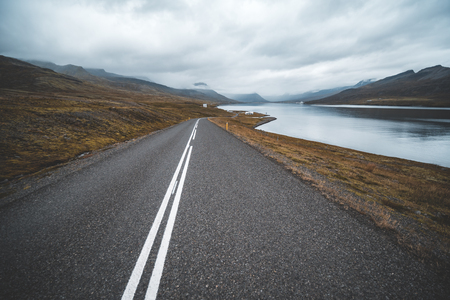 Empty road passing through amazing landscape in Icelandの写真素材