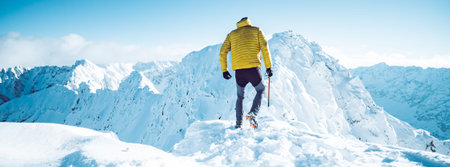 A climber ascending a mountain in winter