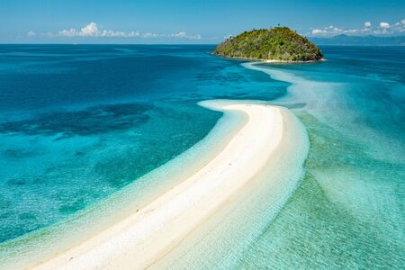 A concept of freedom. Happy woman standing on a spectacular white beachの写真素材
