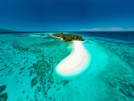 Truly amazing tropical island in the middle of the ocean. Aerial view of an island with white sand beaches and beautiful lagoonsの写真素材