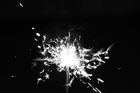Photography of the sparkler with bright sparks isolated on a black backgroundの写真素材
