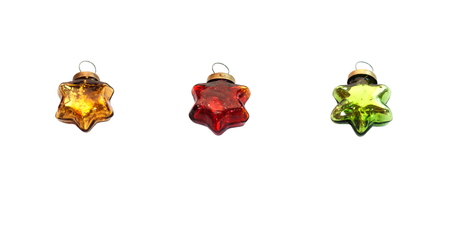 Red, gold and green glassy stars. Christmas toys isolated on white.の写真素材