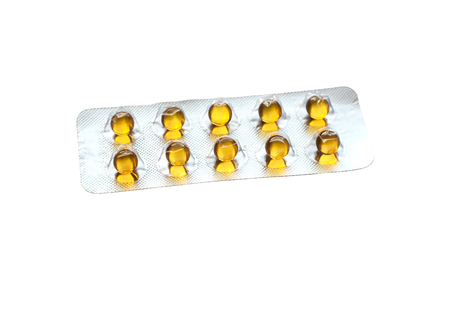 Red round transparent pills in a blister pack isolated on white backgroundの写真素材