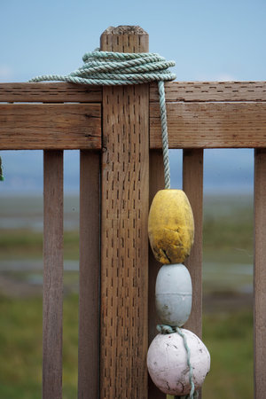 Boat buoys tied to fence