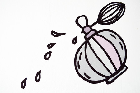 a bottle of perfume with drops on a white backgroundの写真素材