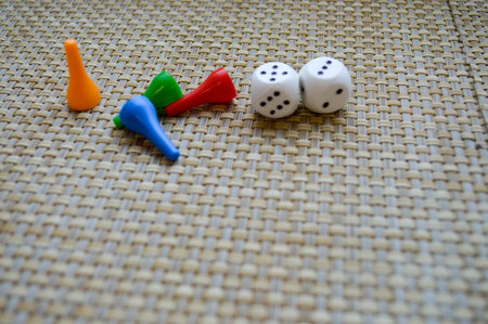 White dice and four figures for table games.