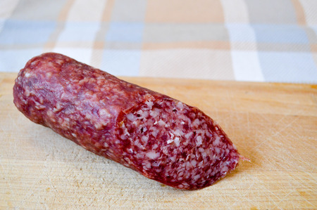 Delicious, red sausage salami on a birch cutting boardの写真素材