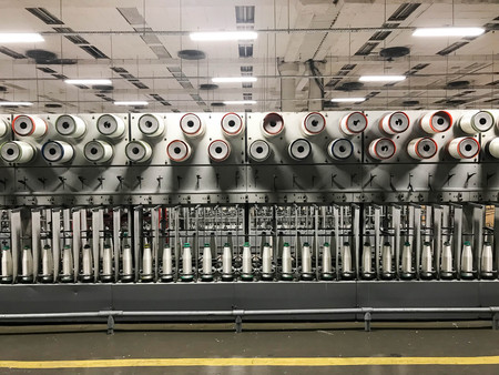 Reels with synthetic threads. Coils with fiberglass. Manufacture of fiberglass. Factory for the production of fiberglass.の写真素材