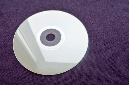 Brilliant compact disc. CD, DVD, Bluray disc on a violet background.