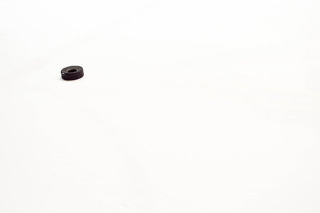 Black rubber small tire for training a game of hockey on the white ice of the hockey arenaの写真素材