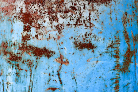 Texture of yellow rusty old shabby coarse rusty unique rust, oxidized metal, iron on blue peeling paint, backgroundの写真素材