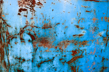 Texture of yellow rusty old shabby coarse rusty unique rust, oxidized metal, iron on blue peeling paint, backgroundの写真素材