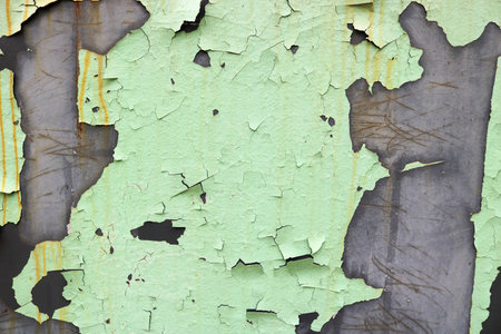 The texture of the old shabby oxidized metal, iron with the expanded peeling green peeling paint and...