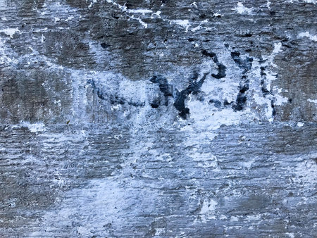 The texture of the old gray concrete cement plaster wall with cracks dent holes patterns and...