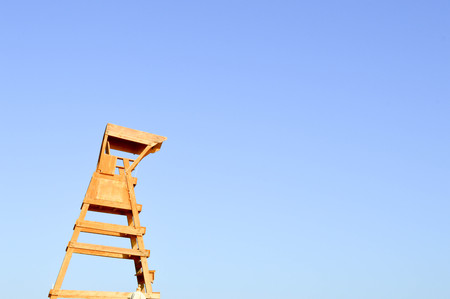 Rescue observation wooden brown tower for the rescuer against the blue sky.の写真素材