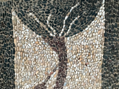 Texture of multicolored stones of different shapes white black hand-made small stems in the form of a beautiful tree, decor element, interior decoration, stone mosaic. The background.の写真素材