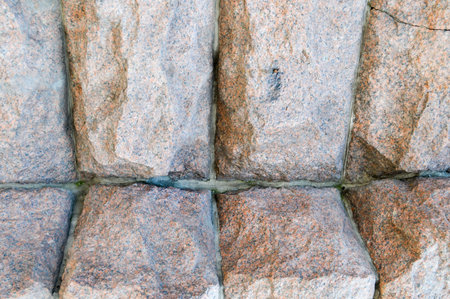 Texture made of huge large sturdy, strong, raised, convex, natural stone, granite of the crooked...