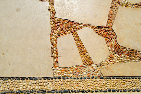 Texture of a stone wall, roads from stones, bricks, cobblestones, tiles with sandy seams of gray...
