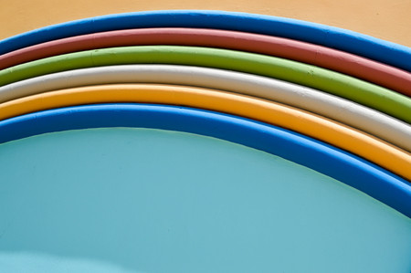 Texture of a cheerful beautiful colorful multicolored abstract colorful bright motley festive rainbow arc of decorative stucco stone on a blue and yellow background. The background.の写真素材