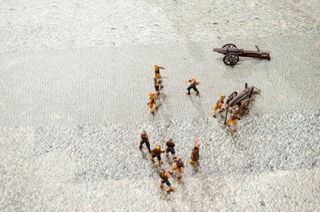 Small action figures of toy soldiers of people with guns and weapons.の写真素材