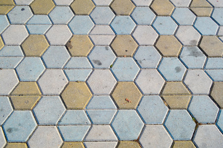 Texture of gray rectangular concrete stone paving slabs on the road with seams. The background.