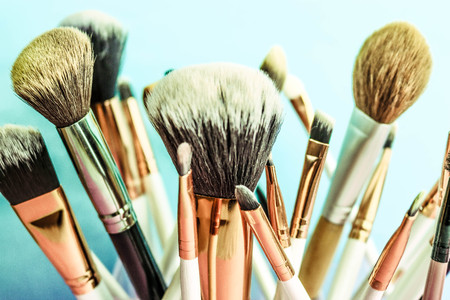 A set of beautiful different soft brushes for make-up from natural nap for the guidance of beauty and the application of a tonal foundation in a stand.の写真素材