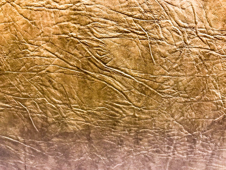 Beautiful abstract texture of yellow brown artificial eco leather with embossed pattern. The background.の写真素材