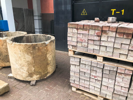 Large round concrete cement stone circles rings wells and paving stone tiles on wooden paddons at a...