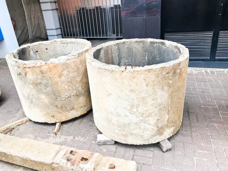 Large round concrete cement stone circles rings wells at a construction site.の写真素材