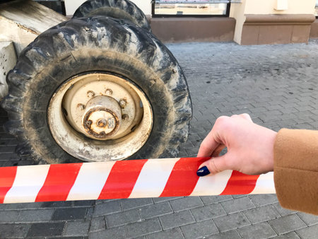 Powerful big wheels with tread and tires of off-road construction equipment, tractors, cars against...