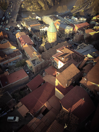 Vertical view from the top from a height of a beautiful tourist city with buildings and houses,...