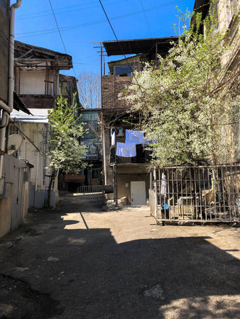 Narrow street, lane, tunnel with old houses, buildings on the sides in a poor area of the city,...