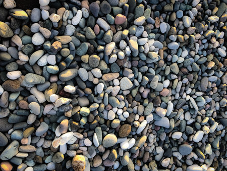 Texture of many multicolored beautiful round and oval smooth natural stones, pebbles. The...
