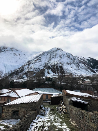 Small stone houses, buildings in the village on a beautiful mountain cold winter resort with high...