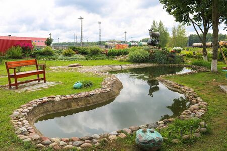 Beautiful small small pond stone natural homemade in nature. Landscaping with artificial pond.の写真素材