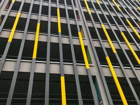 The texture of the wall from the left and right decorative vertical sticks of the boards of the panels yellow and gray. Decorative decoration of the facade of the building. The background.の写真素材