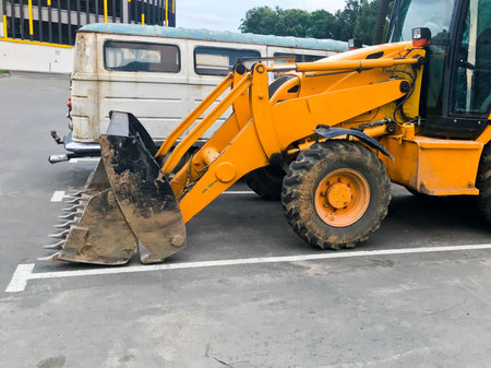 Big powerful iron orange excavator construction with a metal bucket. Construction machinery,...