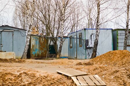 Small temporary houses of builders from containers at an industrial construction site. Block-modular construction city with change houses for workers.の写真素材