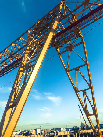 gantry crane for the construction of a subway in the city center, yellow, against the sky....