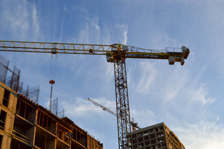 construction of a new residential building from concrete blocks. crane builds a new floor, pulls...