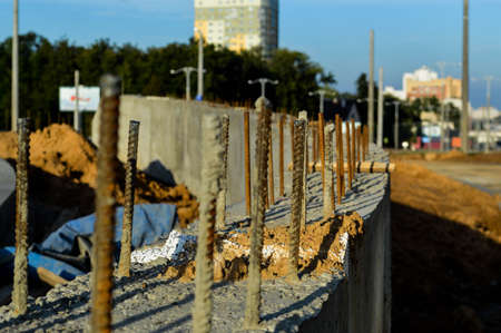 rusty pins sticking out of concrete blocks. laying of blocks for the construction of a new building. block technology for manufacturing houses. making the foundation of the future home.の写真素材